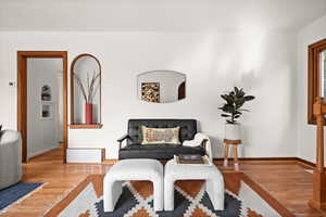 Sitting room featuring visible vents, baseboards, and wood finished floors