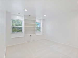 Unfurnished room featuring baseboards, recessed lighting, visible vents, and light colored carpet