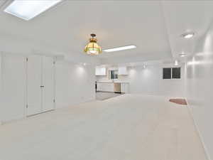 Interior space with light colored carpet and baseboards