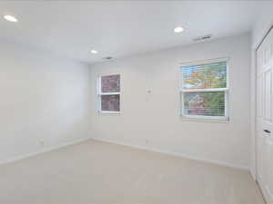 Unfurnished room featuring light carpet, recessed lighting, visible vents, and baseboards