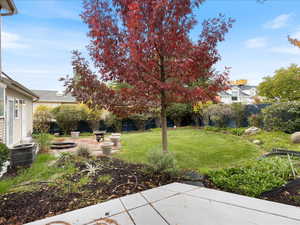 View of yard with fence, central AC, and a patio