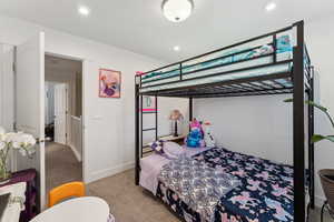 Carpeted bedroom featuring baseboards and recessed lighting