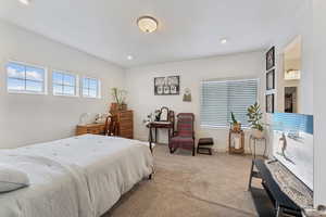 Bedroom with light carpet and baseboards