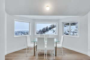 Dining area featuring light wood-type flooring and baseboards