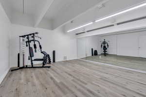 Exercise area featuring wood finished floors and visible vents