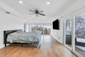 Bedroom with light wood-type flooring, baseboards, visible vents, and recessed lighting