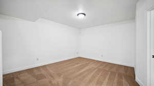 Carpeted empty room with baseboards