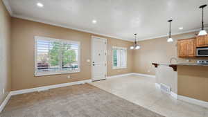 Kitchen with stainless steel microwave, a kitchen bar, visible vents, and a wealth of natural light