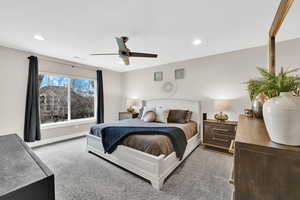 Carpeted bedroom with baseboards, a ceiling fan, and recessed lighting