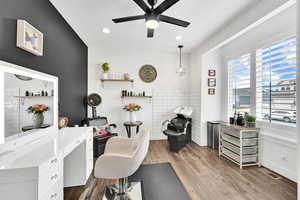 Office area featuring baseboards, visible vents, a ceiling fan, wood finished floors, and recessed lighting