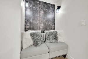 Sitting room with baseboards and wood finished floors