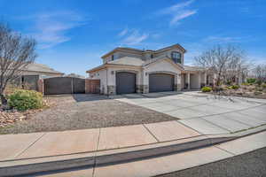 View of front of property featuring driveway, stone siding, a tile roof, a gate, and stucco siding