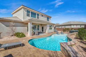 Back of house with stucco siding, fence, outdoor lounge area, and a patio