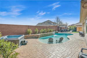 View of swimming pool featuring a fenced backyard, a gazebo, a fenced in pool, a patio area, and a hot tub