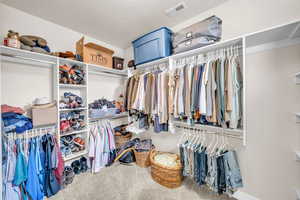 Walk in closet with carpet and visible vents