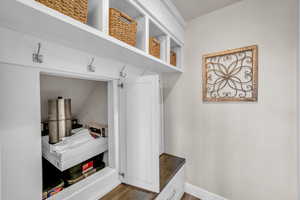 Mudroom with wood finished floors and baseboards