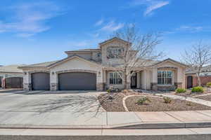 View of front of property featuring a garage, stone siding, a gate, and fence