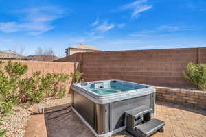 View of patio / terrace with a fenced backyard and a hot tub