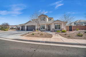 View of front of property with an attached garage, fence, concrete driveway, a gate, and stucco siding