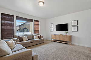 Living room featuring baseboards and carpet flooring