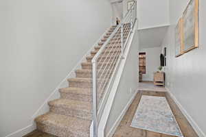Stairs featuring baseboards and wood finished floors