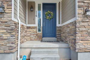 Property entrance with stone siding