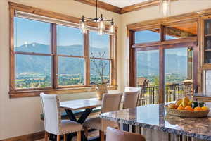 Dining space with plenty of natural light, a mountain view, and crown molding