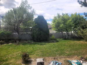 View of yard featuring fence