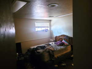 Bedroom featuring a textured ceiling