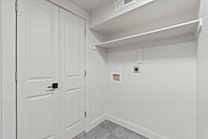 Clothes washing area featuring laundry area, baseboards, visible vents, hookup for an electric dryer, and washer hookup