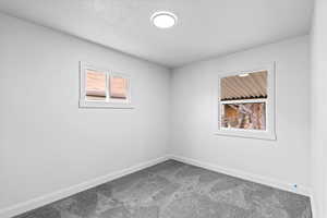 Unfurnished room with carpet floors and baseboards