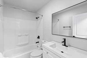 Bathroom featuring shower / tub combination, vanity, and toilet