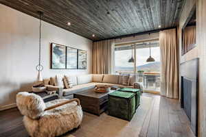 Living room featuring recessed lighting, wooden ceiling, and hardwood / wood-style flooring