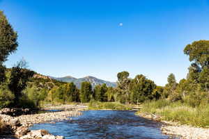 Water view featuring a mountain view and a view of trees