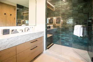 Bathroom with a shower stall and vanity