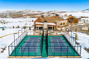 View of sport court with fence and a mountain view