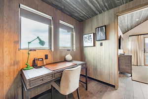 Home office featuring light wood-type flooring, a wealth of natural light, wood ceiling, and lofted ceiling