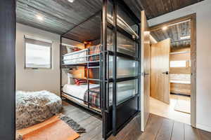 Bedroom with wooden ceiling and hardwood / wood-style floors