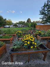 View of yard with a garden and fence