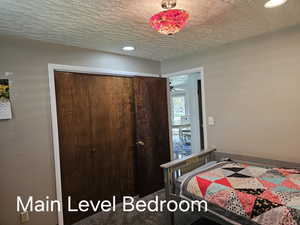 Bedroom with a closet and a textured ceiling