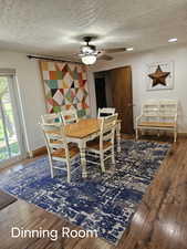 Dining area featuring a textured ceiling, ceiling fan, hardwood / wood-style floors, and baseboards