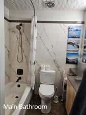 Full bath featuring toilet, vanity, shower / bath combination with curtain, and visible vents