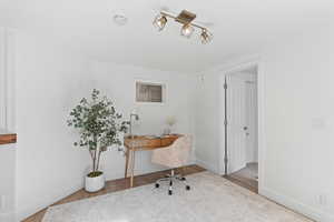 Office space featuring wood finished floors and baseboards