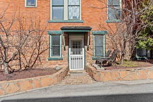 Entrance to property featuring brick siding