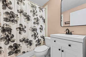 Full bath featuring vanity and toilet