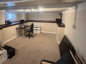 Carpeted office featuring baseboards