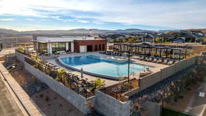 Pool with a patio area, a mountain view, and a hot tub