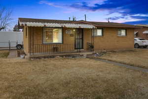 View of front of property with a lawn