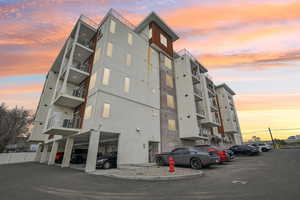 Property at dusk with uncovered parking