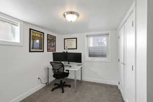 Office area featuring carpet floors and baseboards